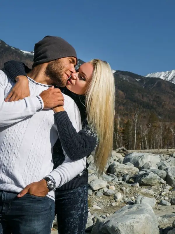 kissing on top of a mountain